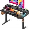 Amazon :$97.49 ($179.99)ErGear Standing Desk with LED Strip, 48'' x24'' Electric Height Adjustable RGB Gaming Desk with Shelf, Sit Stand Desk with Dual Cable Holes, C-Clamp Mount Compatible, 4 Preset Heights, Black