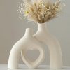 Amazon: $11.95 ($25.98) Modern Ceramic Vase, Snuggle Heart-Shaped Abstract Sculpture Vases
